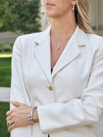 photo of a woman wearing gemstone jewelry