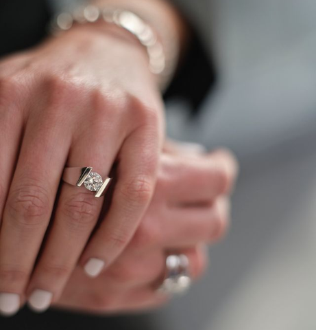 woman wearing a solitaire engagement ring with channel setting