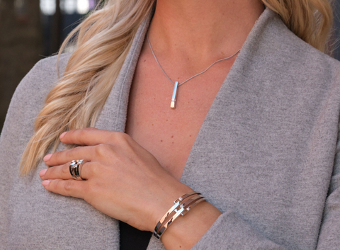 closeup of a woman wearing a statement diamond pendant by John Atencio