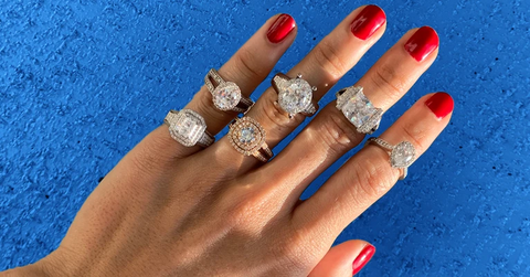 womans hand displaying variety of engagement rings from John Atencio