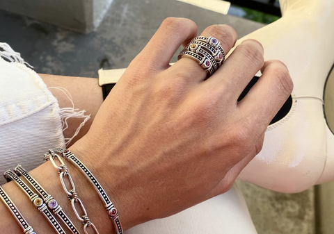 woman wearing stacked rings to celebrate lifes milestones
